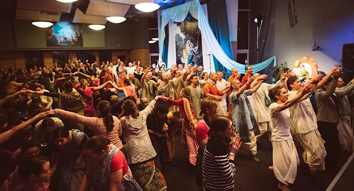 Devotees dancing together in ecstatic kirtan